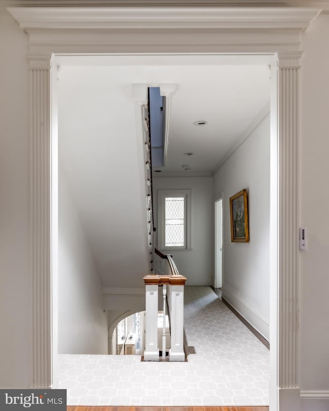 hall featuring baseboards and ornamental molding