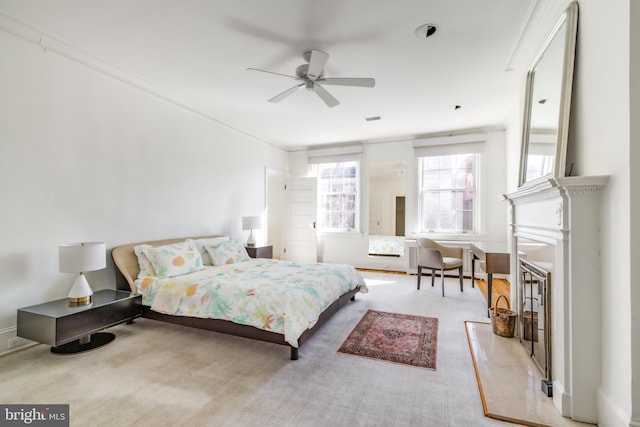 carpeted bedroom with visible vents and a fireplace with raised hearth