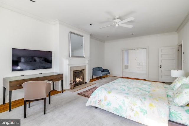 bedroom featuring baseboards, ensuite bath, ornamental molding, and a high end fireplace