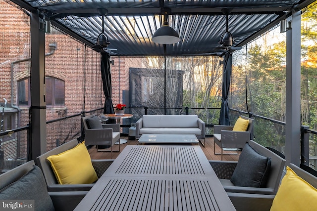 sunroom with a wealth of natural light and ceiling fan