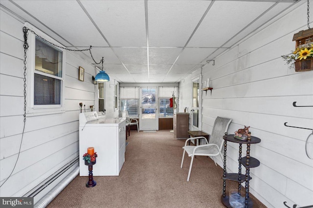 interior space featuring washing machine and dryer and a drop ceiling