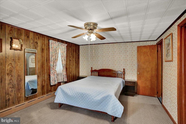 bedroom featuring a baseboard heating unit, a ceiling fan, carpet flooring, and wallpapered walls