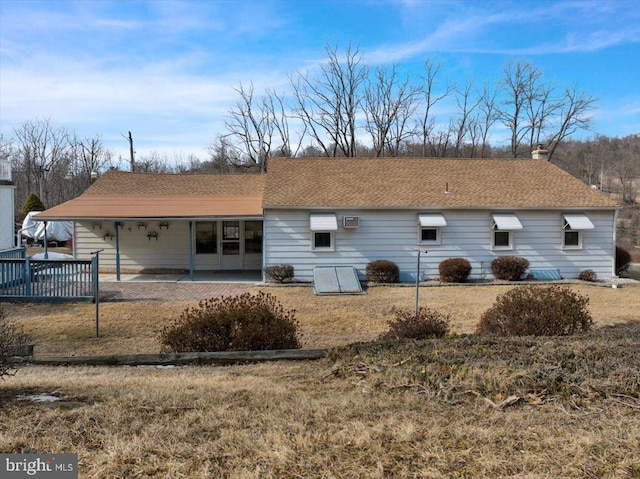 back of house featuring a shingled roof and a patio