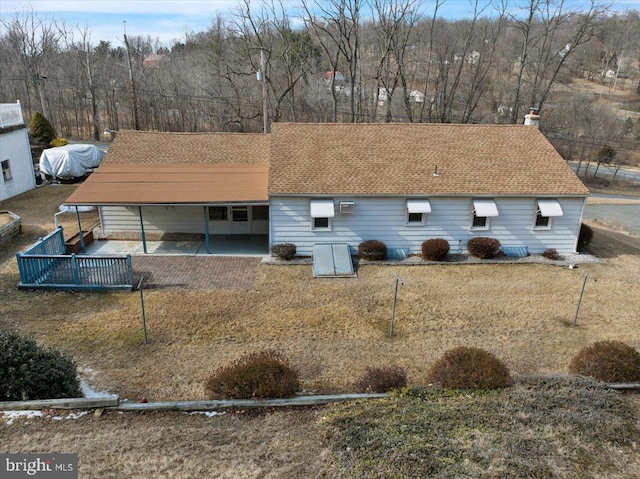 view of front of property with a shingled roof and a chimney