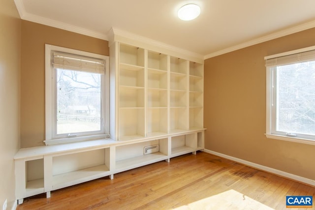 mudroom with plenty of natural light, baseboards, crown molding, and wood finished floors