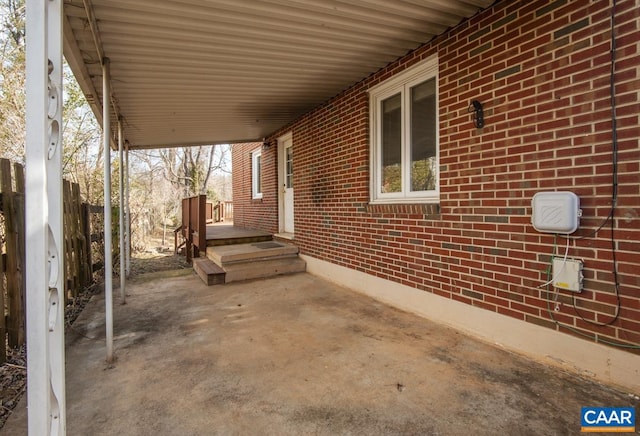 view of patio featuring fence and a carport