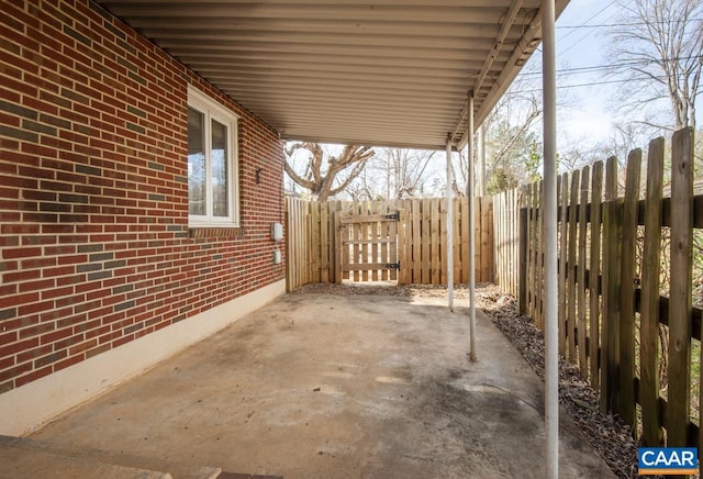 view of patio / terrace featuring a fenced backyard and a carport