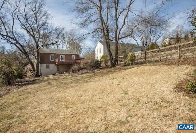 view of yard with fence and a wooden deck