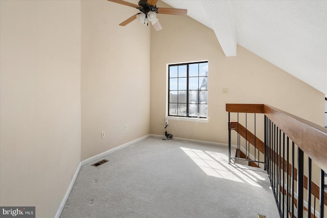 additional living space with lofted ceiling, baseboards, visible vents, and carpet flooring