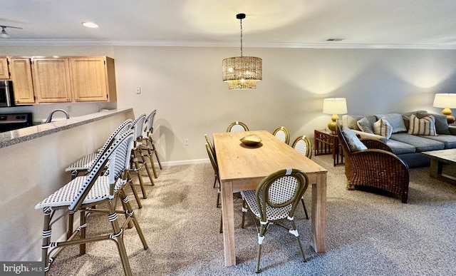 dining area featuring light carpet, ornamental molding, and baseboards