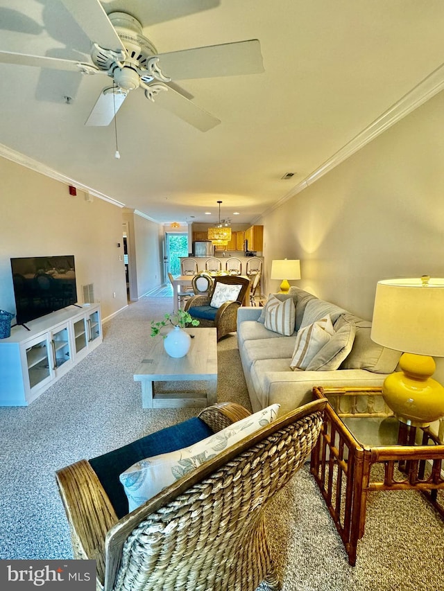 living room with ceiling fan, carpet flooring, visible vents, and crown molding