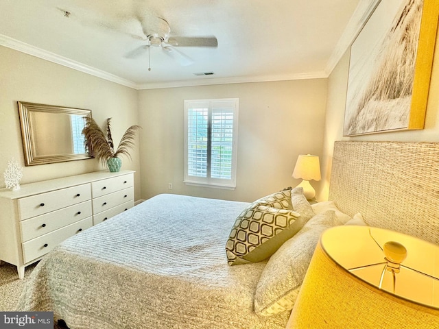 bedroom with visible vents, a ceiling fan, and ornamental molding