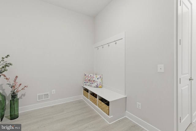 mudroom featuring light wood-style floors, baseboards, and visible vents