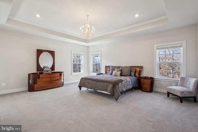 bedroom featuring multiple windows, carpet, a raised ceiling, and baseboards