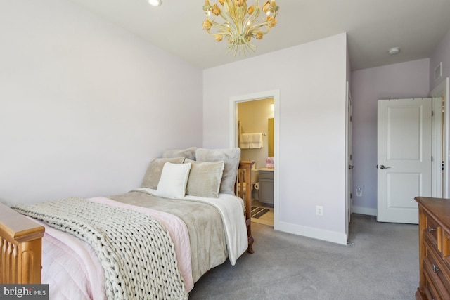 bedroom with a notable chandelier, carpet floors, visible vents, baseboards, and ensuite bath