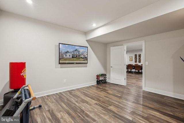 workout room featuring recessed lighting, baseboards, and wood finished floors