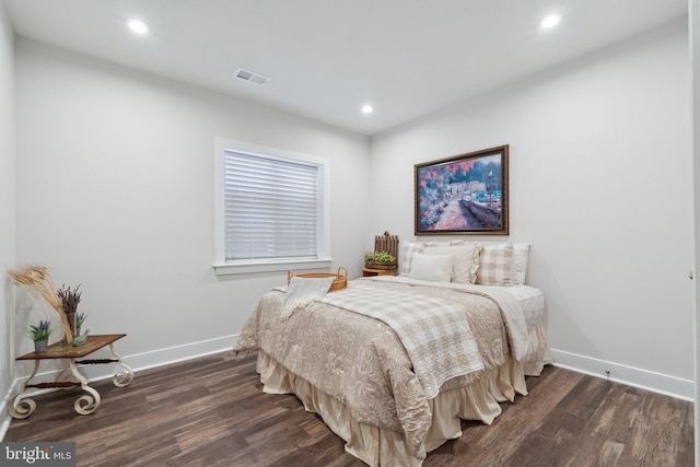 bedroom featuring dark wood finished floors, visible vents, and baseboards