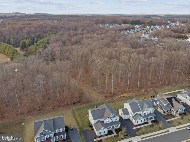 aerial view featuring a forest view and a residential view