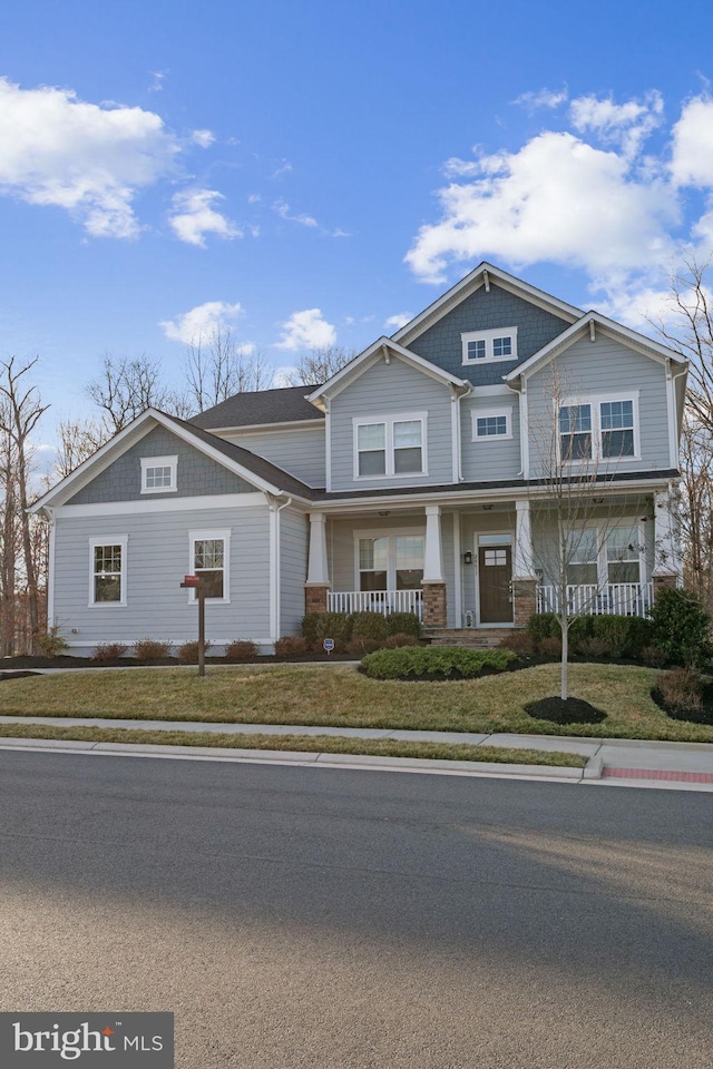 view of front of house with a front lawn and a porch