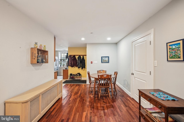 dining room featuring dark wood-style floors, washer / dryer, baseboards, and recessed lighting