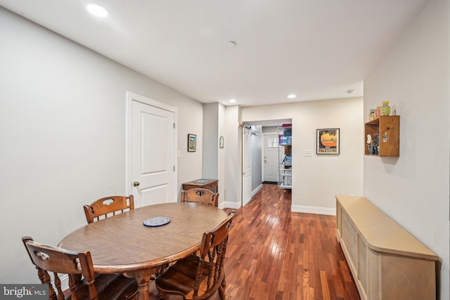 dining area with recessed lighting, wood-type flooring, and baseboards