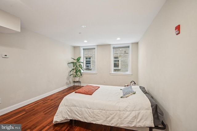 bedroom with recessed lighting, wood finished floors, and baseboards