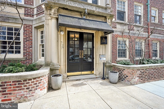 property entrance with french doors and brick siding