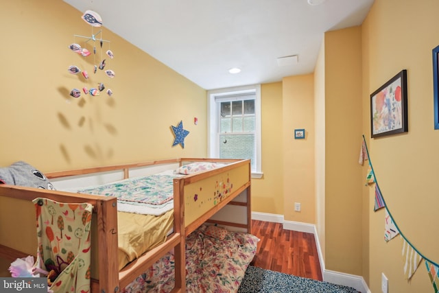 bedroom with baseboards and wood finished floors