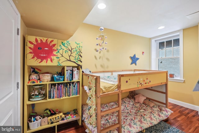 bedroom with recessed lighting, wood finished floors, and baseboards