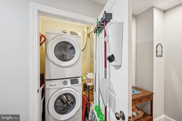 clothes washing area with stacked washer / dryer and laundry area