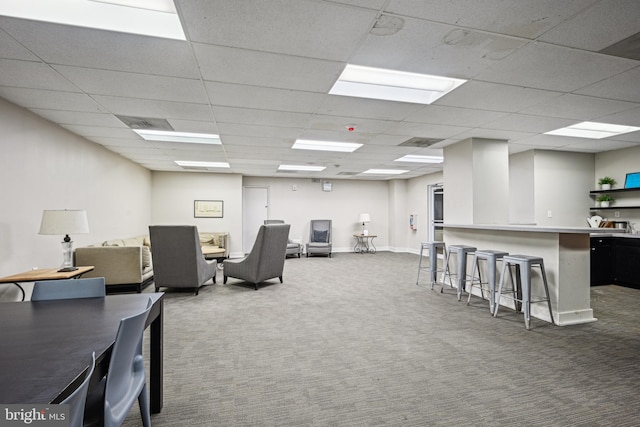 interior space featuring carpet floors, a paneled ceiling, and baseboards