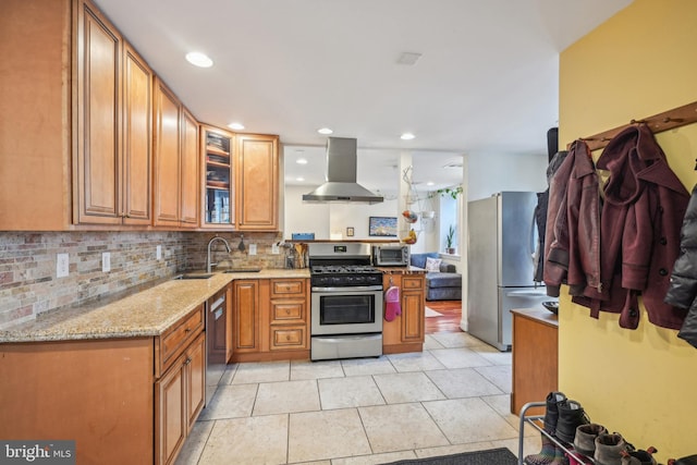 kitchen featuring stainless steel appliances, tasteful backsplash, brown cabinetry, and extractor fan