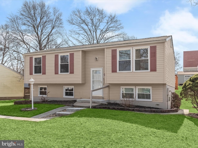 split foyer home with a front lawn