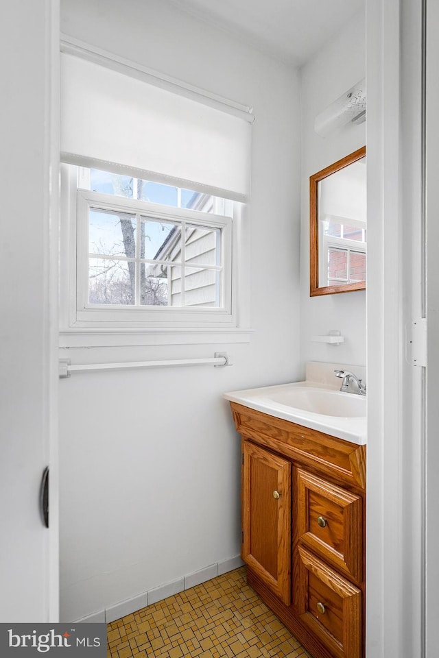 bathroom with vanity and baseboards