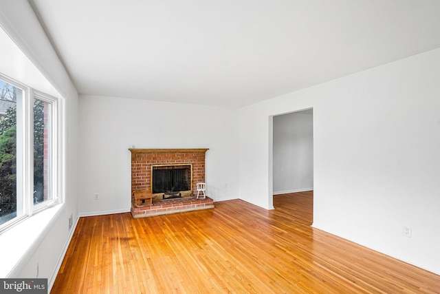 unfurnished living room with light wood finished floors and a fireplace