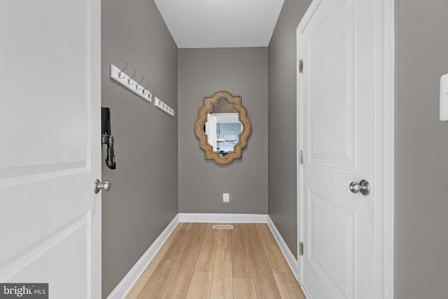 doorway to outside featuring light wood-type flooring and baseboards