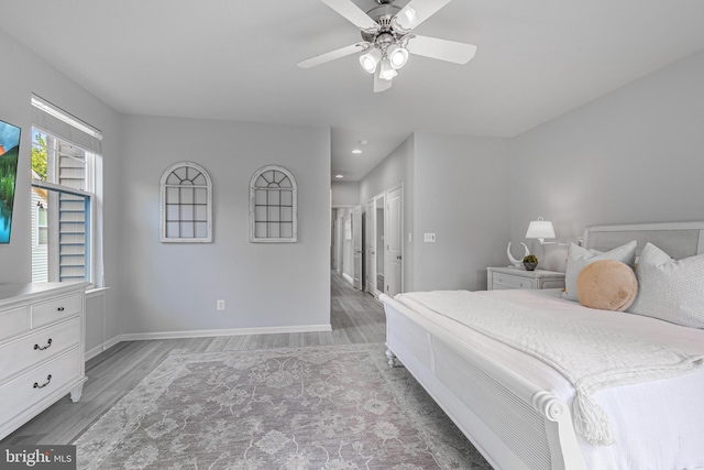 bedroom with recessed lighting, light wood-type flooring, a ceiling fan, and baseboards