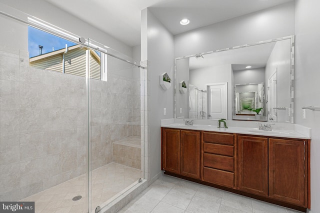 full bathroom with tile patterned flooring, recessed lighting, a sink, double vanity, and a stall shower