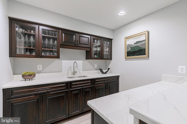 bar with a sink, light wood-style flooring, and recessed lighting