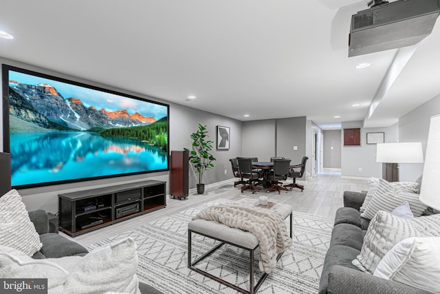 home theater room with baseboards, wood finished floors, and recessed lighting