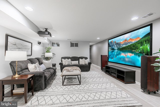 home theater featuring wood finished floors, visible vents, and recessed lighting