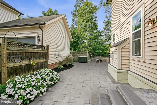 view of property exterior with a patio area and fence