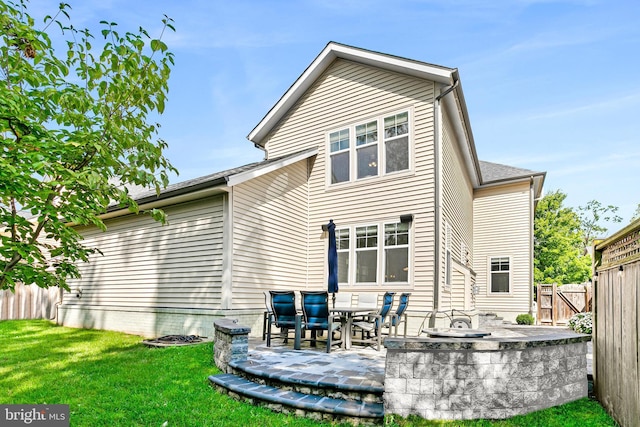 rear view of house featuring a yard and fence