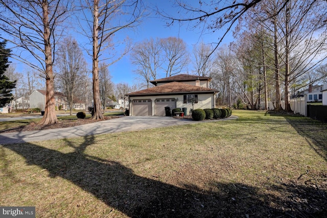 view of yard with aphalt driveway and an attached garage