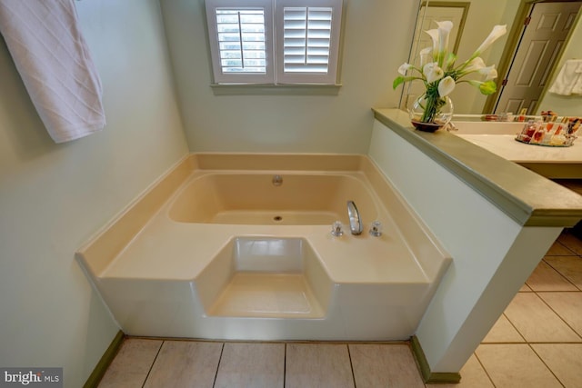 bathroom with tile patterned floors and a bath