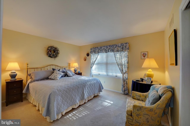 bedroom featuring light colored carpet, visible vents, and baseboards