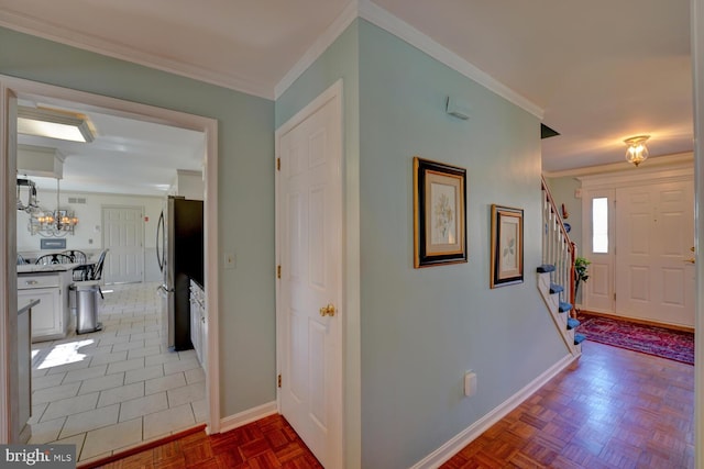 entrance foyer featuring baseboards, stairway, and crown molding