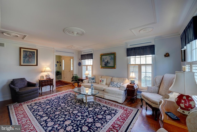 living room with a healthy amount of sunlight, visible vents, and ornamental molding