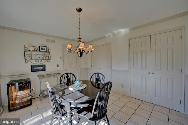 dining space with light tile patterned floors, visible vents, a chandelier, and crown molding