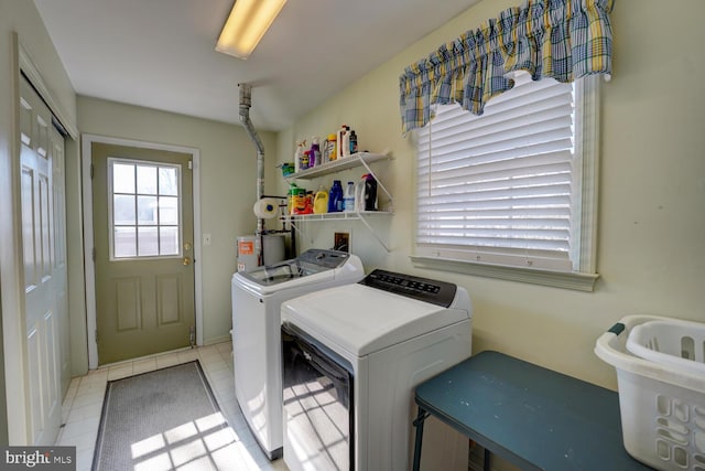 washroom featuring washer and dryer, laundry area, and tile patterned floors